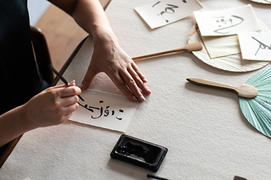Woman draws in Japanese script
